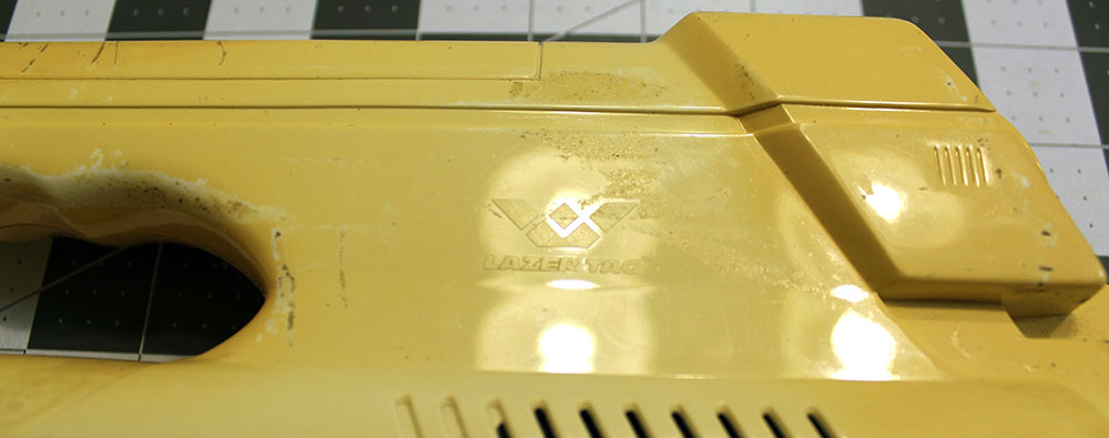 closeup on the World of Wonder and Lazer Tag logos molded in the left side of the rifle